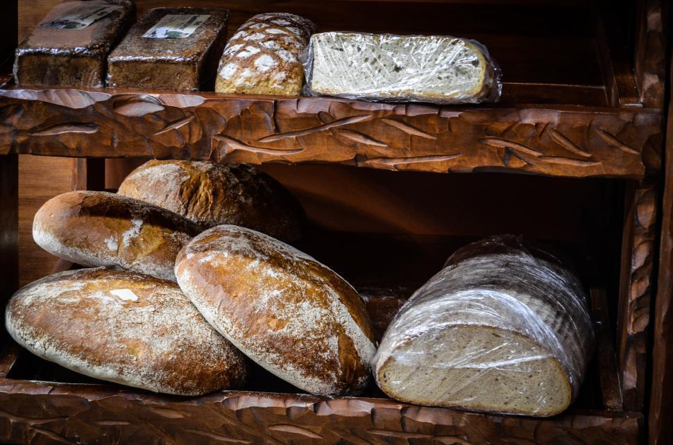 Fresh bread loaves on wooden shelves